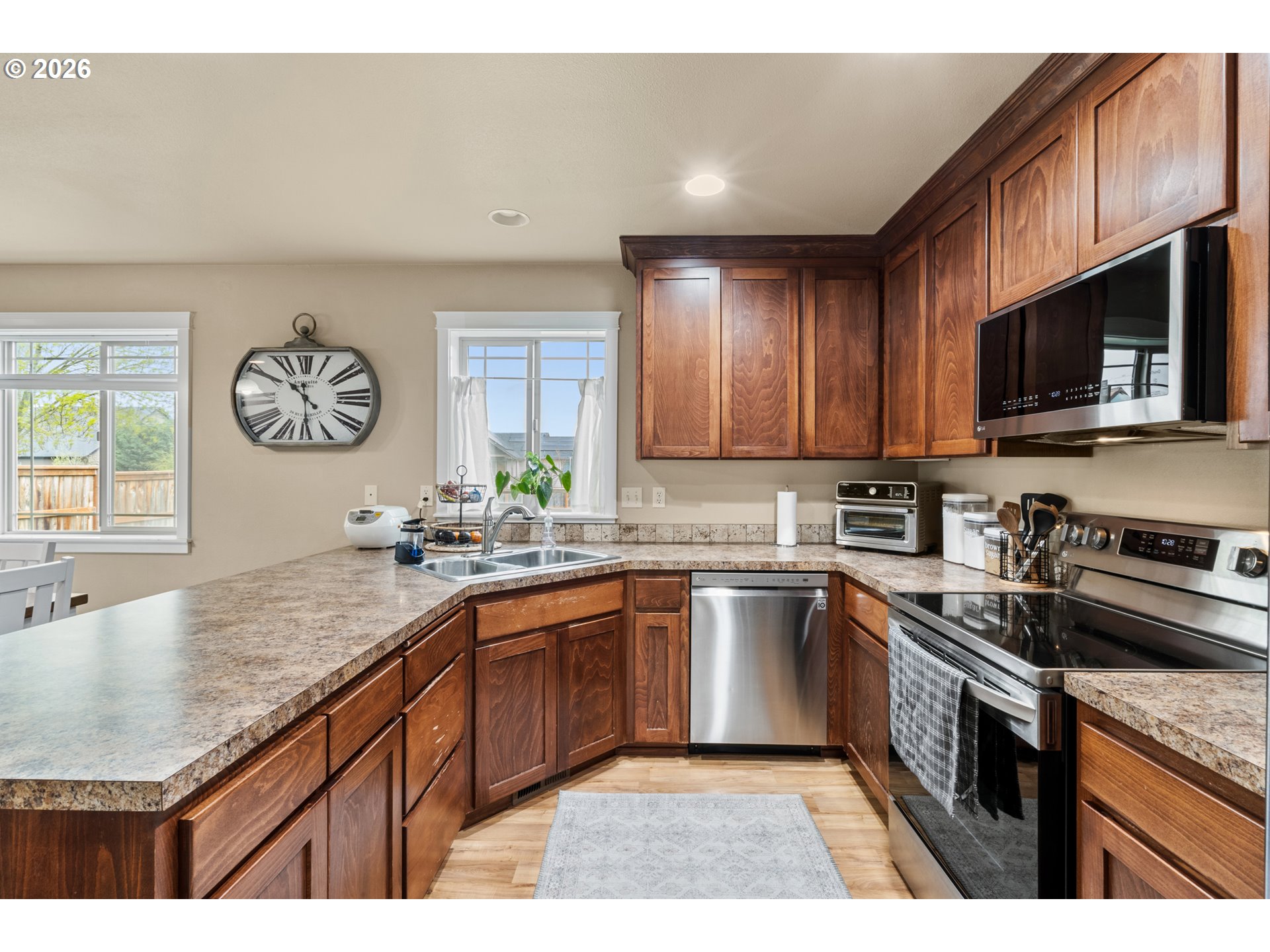 4971 Northeast Terri Lane Albany, OR 97321 - Photo 5 of 44 a kitchen with stainless steel appliances granite countertop a sink stove microwave and cabinets