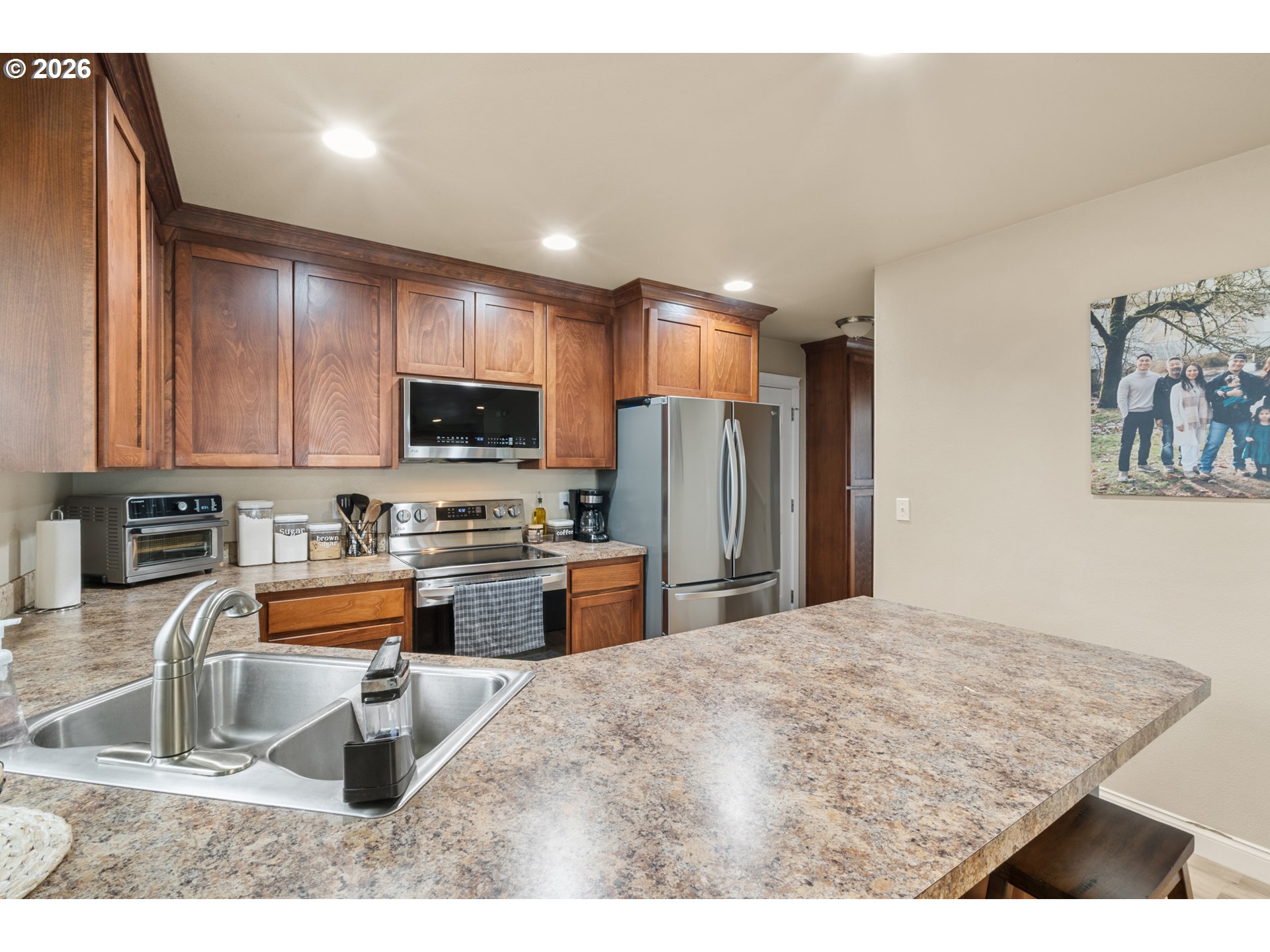 4971 Northeast Terri Lane Albany, OR 97321 - Photo 7 of 44 a kitchen with stainless steel appliances granite countertop a refrigerator a stove top oven a sink and dishwasher