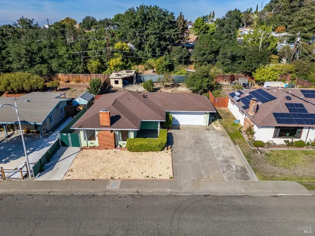 an aerial view of residential houses with outdoor space