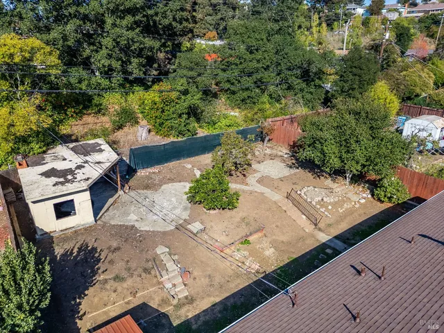 an aerial view of a house with a yard