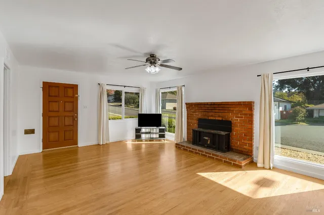 a view of livingroom with furniture a fireplace and wooden floor