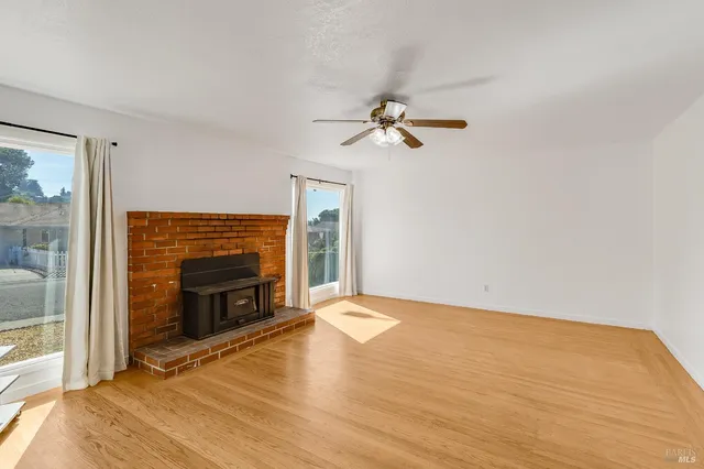 a view of empty room with a fireplace