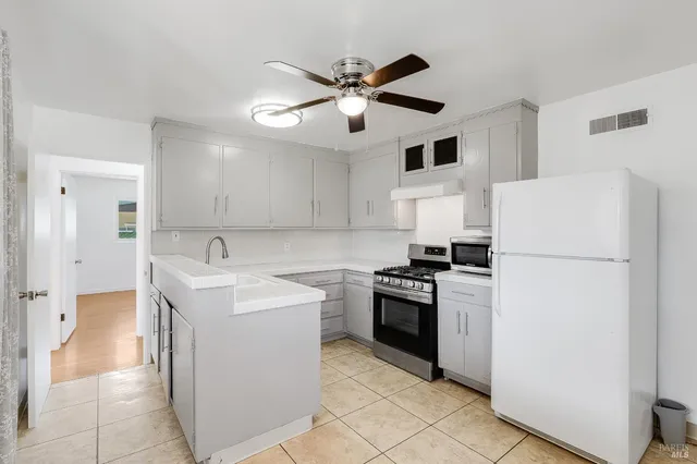 a kitchen with a sink appliances and cabinets