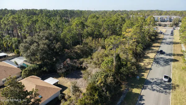 an aerial view of a residential apartment building with a tree