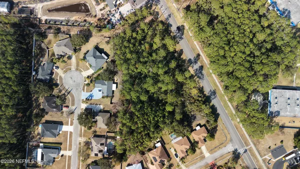 an aerial view of a residential apartment building with plants and large trees