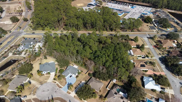 an aerial view of a residential houses with outdoor space and street view