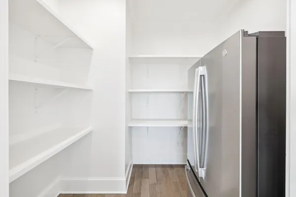 a spacious bedroom with a bed a couch and a flat screen tv