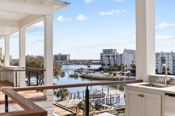 a view of a balcony with wooden floor and outdoor seating