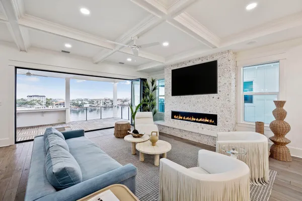 a living room with furniture a flat screen tv and a fireplace