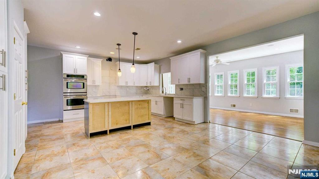 15 Berry Court Flanders, NJ 07836 - Photo 17 of 48 a large kitchen with stainless steel appliances kitchen island granite countertop a refrigerator and a stove top oven
