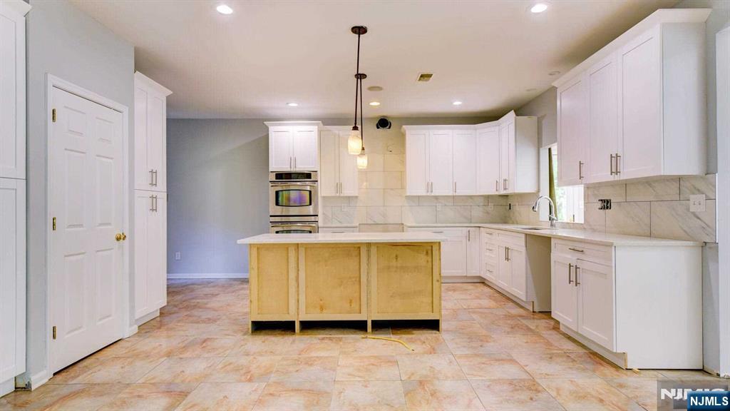 15 Berry Court Flanders, NJ 07836 - Photo 18 of 48 a large kitchen with stainless steel appliances granite countertop a sink a stove and a refrigerator