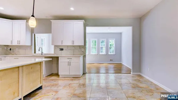 a kitchen with a sink window and cabinets