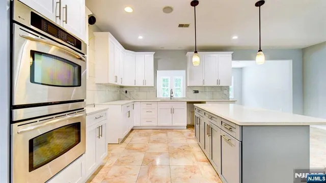 a kitchen with a sink stove and microwave