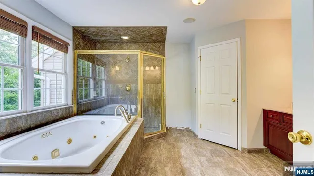 a bathroom with a bathtub and a shower