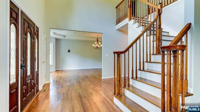 a view of staircase with wooden floor and a large window