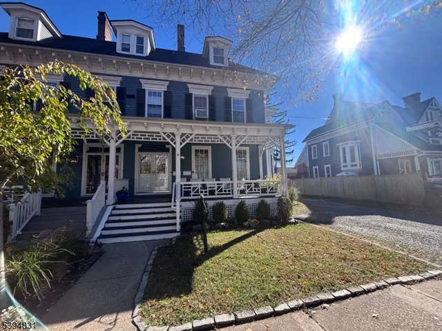 a living room with furniture a chandelier and a flat screen tv