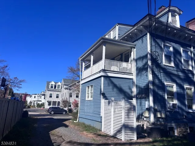 a view of a hallway with furniture and a window