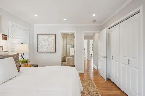 a bedroom with a bed and hallway