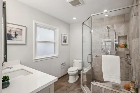 a spacious bathroom with a sink toilet and shower