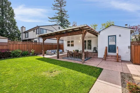 a view of a house with a yard and sitting area