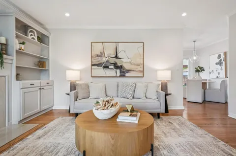 a living room with furniture and a chandelier