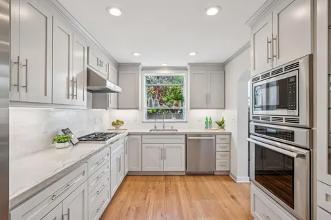 a kitchen with a sink stainless steel appliances and cabinets