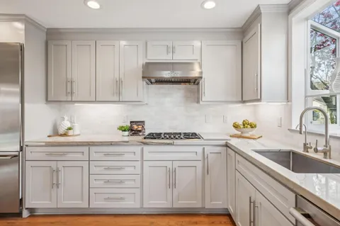 a kitchen with stainless steel appliances granite countertop a sink stove and cabinets