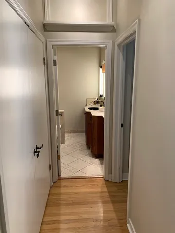 a view of a hallway view with wooden floor and staircase