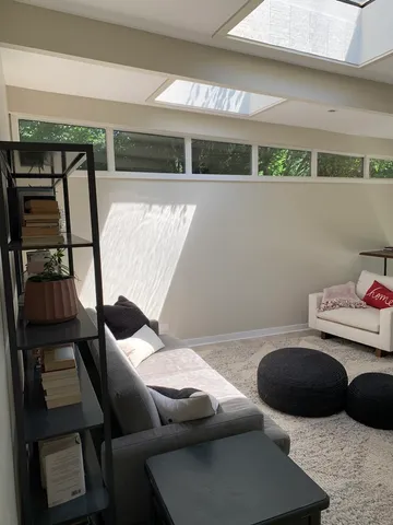 a living room with furniture and a rug