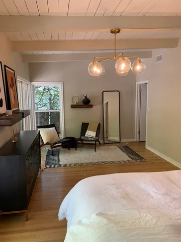 a view of a livingroom with furniture window and wooden floor