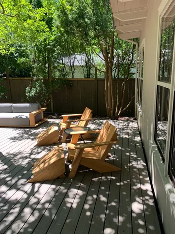 a backyard of a house with table and chairs