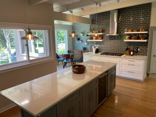 a kitchen with a stove a sink and a wooden cabinets