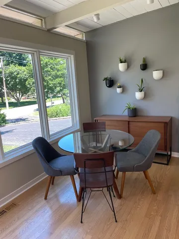 a view of a workspace with furniture and a window