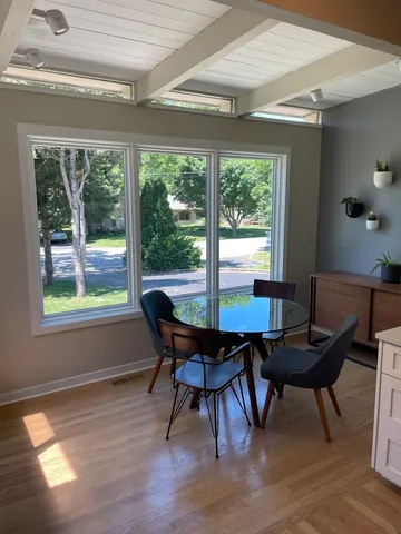 a view of a dining room with furniture and window