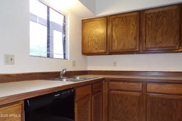 a kitchen with stainless steel appliances granite countertop a sink stove and microwave