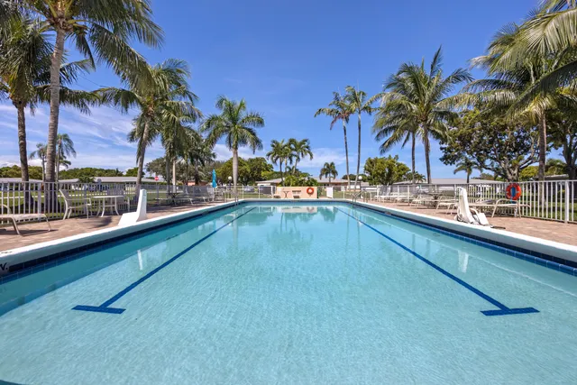 a view of a swimming pool with a table and chairs