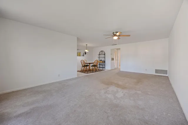 a view of a livingroom with furniture and a ceiling fan