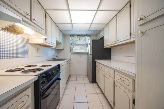a kitchen with a stove cabinets and a sink