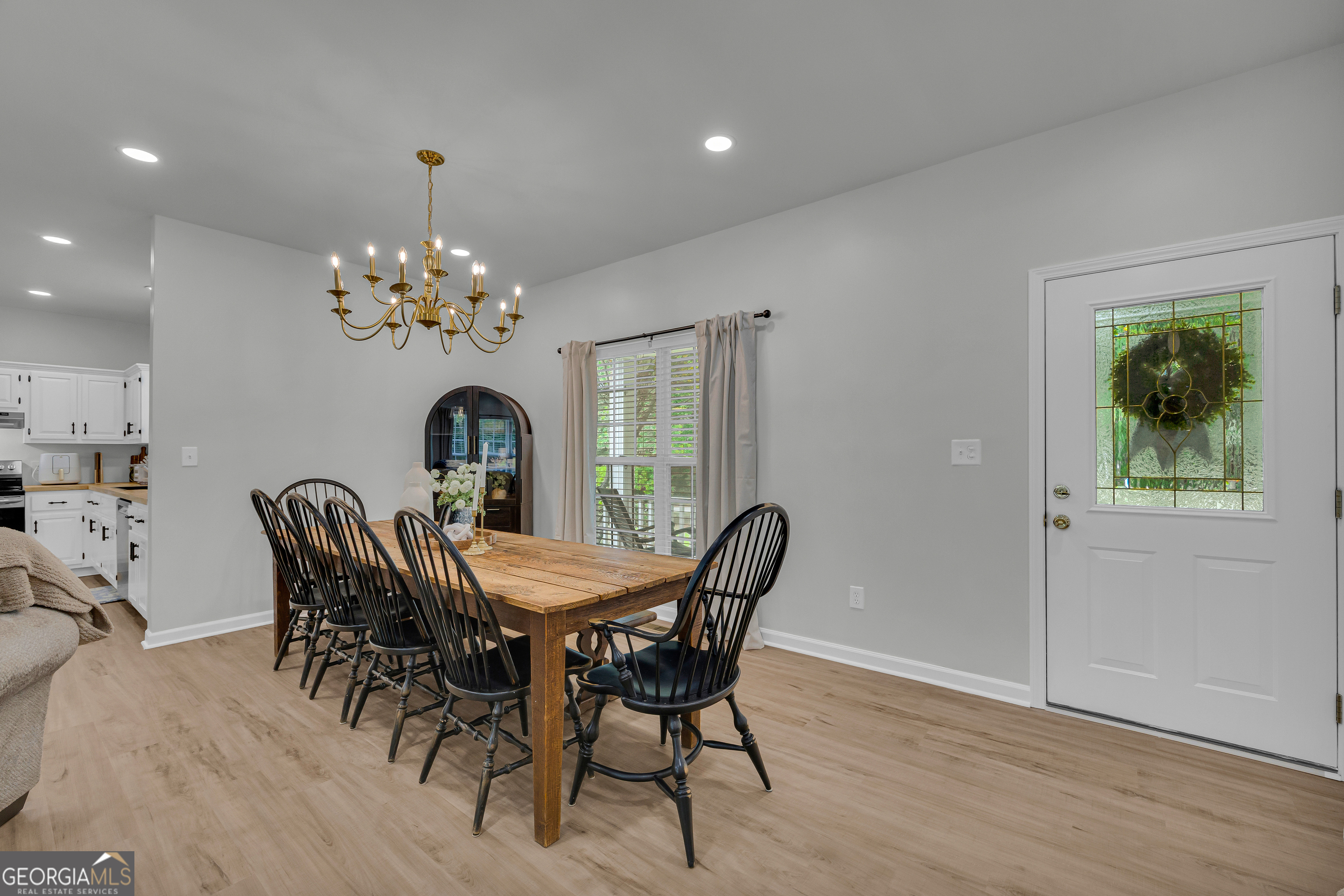 163 Tuxedo Drive Commerce, GA 30530 - Photo 15 of 62 a dining room with furniture a chandelier and wooden floor