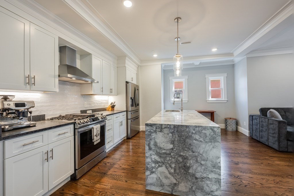 11 Preston Road, Unit 2 Somerville, MA 02143 - Photo 11 of 30 a large kitchen with stainless steel appliances granite countertop a sink stove and refrigerator