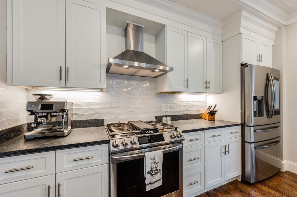 11 Preston Road, Unit 2 Somerville, MA 02143 - Photo 13 of 30 a kitchen with stainless steel appliances granite countertop a sink stove and refrigerator