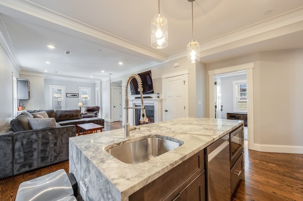 11 Preston Road, Unit 2 Somerville, MA 02143 - Photo 14 of 30 a kitchen with stainless steel appliances granite countertop a sink a oven and a refrigerator