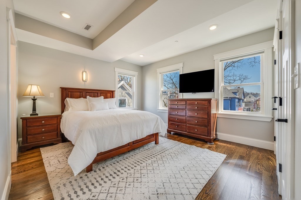 11 Preston Road, Unit 2 Somerville, MA 02143 - Photo 16 of 30 a bedroom with a bed and wooden floor