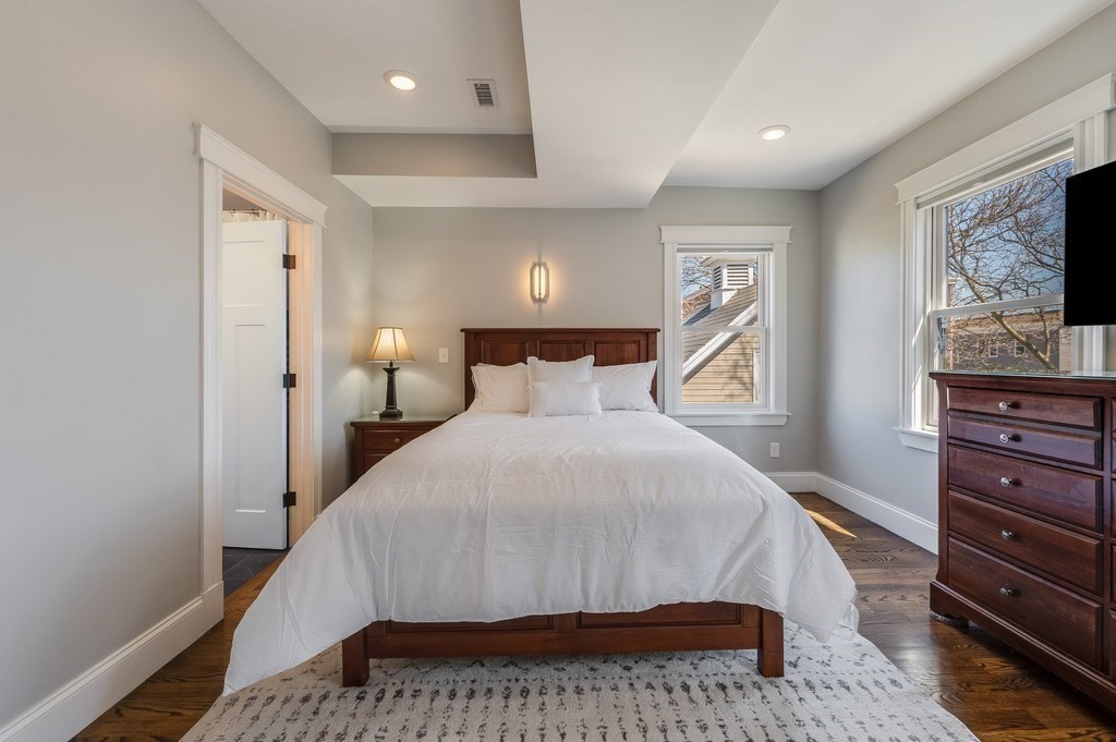 11 Preston Road, Unit 2 Somerville, MA 02143 - Photo 17 of 30 a bedroom with a bed and wooden floor