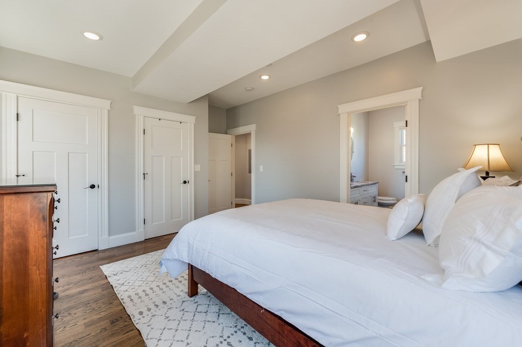 11 Preston Road, Unit 2 Somerville, MA 02143 - Photo 18 of 30 a bedroom with a large bed and wooden floor