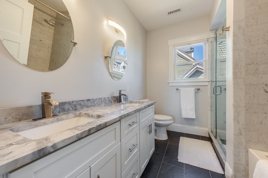 11 Preston Road, Unit 2 Somerville, MA 02143 - Photo 19 of 30 a bathroom with a granite countertop toilet sink and mirror