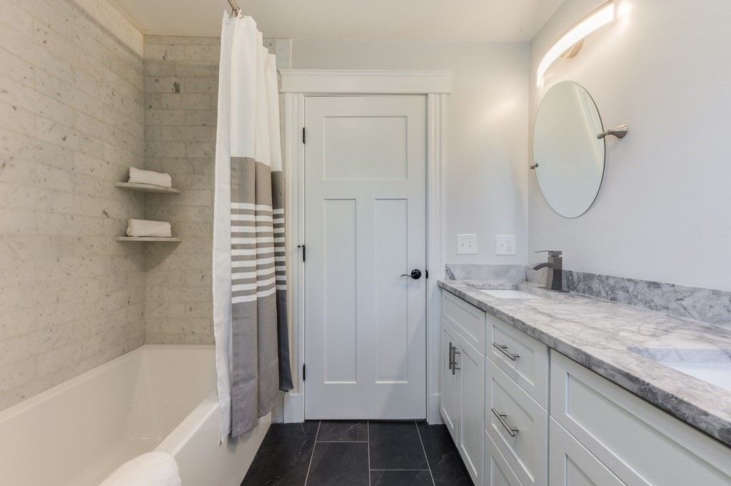 11 Preston Road, Unit 2 Somerville, MA 02143 - Photo 21 of 30 a bathroom with a granite countertop sink mirror and a bathtub