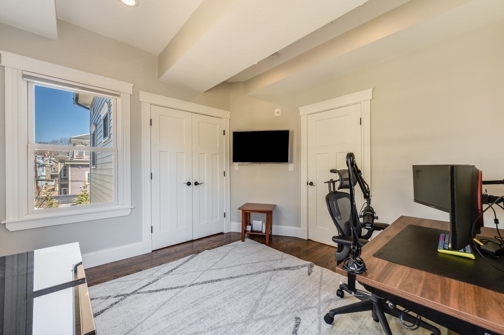 11 Preston Road, Unit 2 Somerville, MA 02143 - Photo 22 of 30 a room with a bed and a flat screen tv