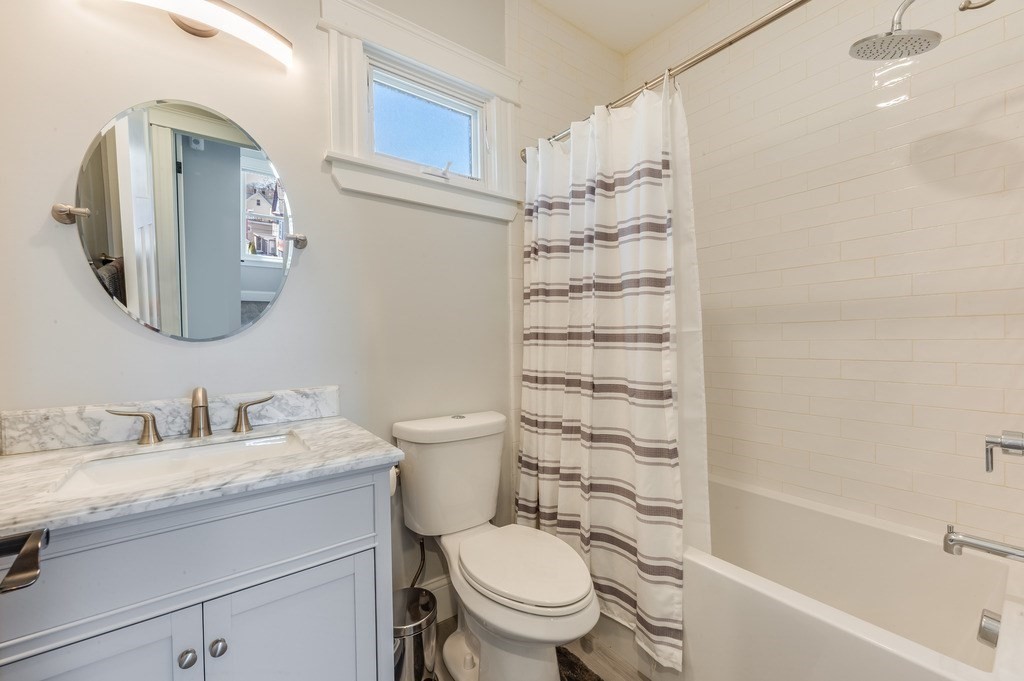 11 Preston Road, Unit 2 Somerville, MA 02143 - Photo 24 of 30 a bathroom with a toilet a sink and a bathtub