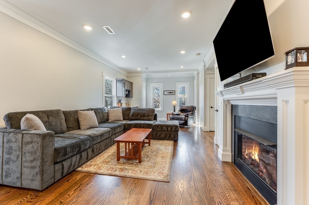 11 Preston Road, Unit 2 Somerville, MA 02143 - Photo 4 of 30 a living room with furniture fireplace and flat screen tv